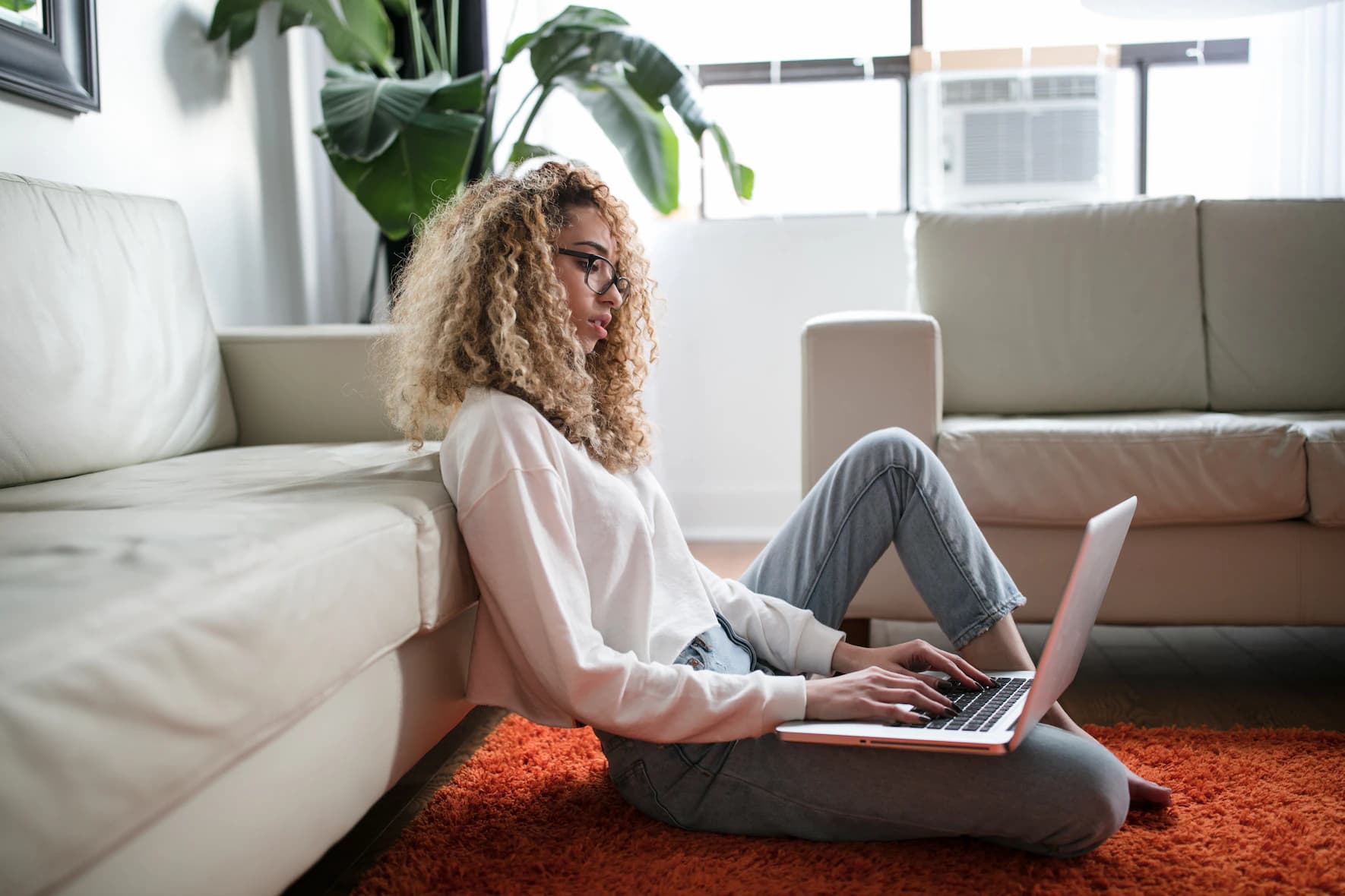 woman in her home with a laptop